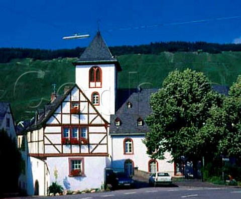 White woodframed houses in Wehlen with beyond on   the far side of the Mosel the Sonnenuhr vineyard   Germany Mosel