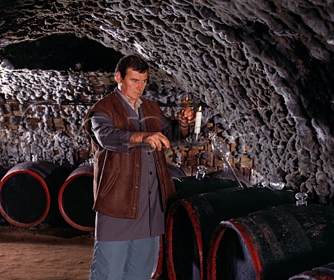 Checking the clarity of wine taken from barrel in the ancient mouldcovered cellars of Tokaj Kereskedhz Tolcsva Hungary  Tokaji