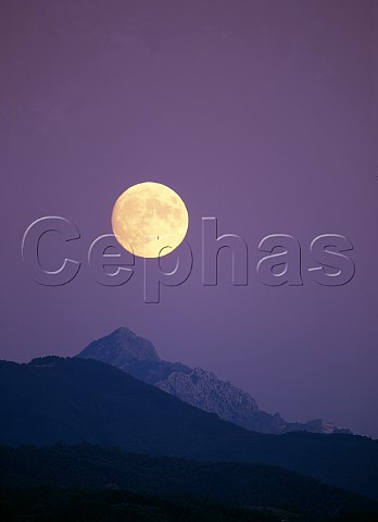 Full moon over the Alpi Apuane viewed from near La Spezia Tuscany from Liguria Italy