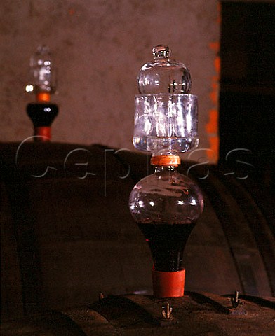 Air lock in barrel of Chianti which is undergoing   the malolactic fermentation in the Spring following   harvest Riecine estate Gaiole in Chianti Tuscany   Chianti Classico