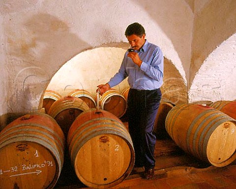 Consultant winemaker Maurizio Castelli checking a   sample of Balifico a vdt of Sangioveto Mammolo and   Cabernet from barrique in the cellars of Castello di   Volpaia Tuscany   Chianti Classico