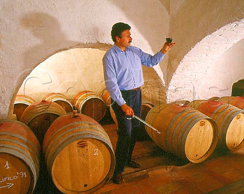 Consultant winemaker Maurizio Castelli checking a   sample of Balifico a vdt of Sangioveto Mammolo and   Cabernet from barrique in the cellars of Castello di   Volpaia Tuscany   Chianti Classico