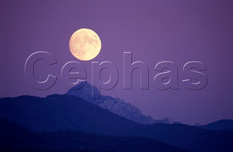 Full moon over the Alpi Apuane viewed from near La Spezia Tuscany from Liguria Italy