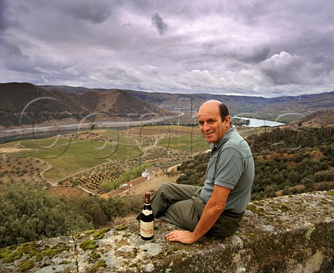 Francisco Olazabal with bottle of  Barca Velha above vineyards of Quinta do Vale Meo  Vila Nova de Foz Coa Portugal Douro  Port
