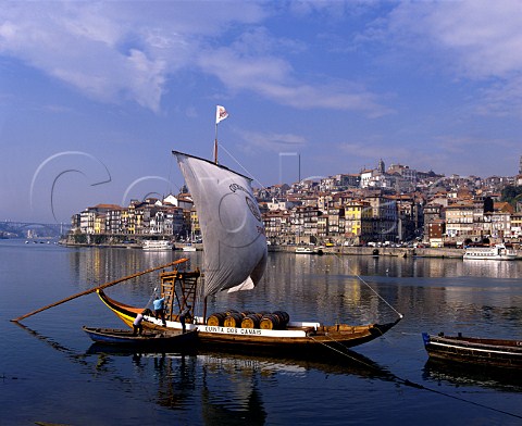 View across the Douro from Vila Nova de Gaia to Porto Portugal Until the river was dammed the barcos rabelos moored here were used to transport pipes of port from the quintas high up the valley