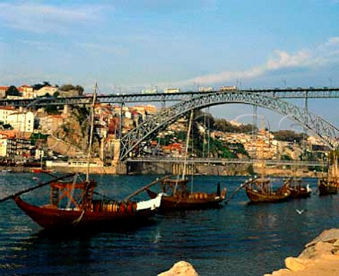 Barcos rabelos moored on the Douro Eiffels Ponte de Dom Luis I spans the river from Vila Nova de Gaiato Porto on the far bank Before the river was dammed the boats were used to transport pipes of port down river from the quintas high up the valley