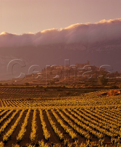 Stormy evening light on the hilltop town of  Laguardia with cloud clinging to the ridge of the  Sierra de Cantabria beyond Alava Spain  Rioja  Alavesa