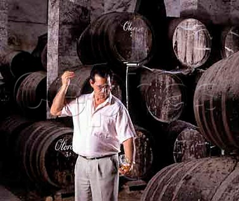 Angel Barcia Capataz foreman of the bodega   taking Oloroso from barrel using a venencia in La   Palma bodega of Osborne Puerto de Santa Maria   Spain Sherry