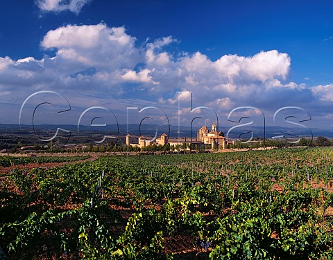 The 12thcentury Monastery of Poblet viewed over a   vineyard of Familia Torres Catalonia Spain  Conca de Barbera DO
