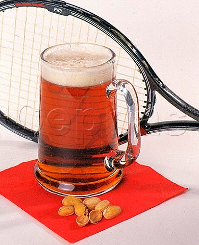 Glass of bitter with squash racket