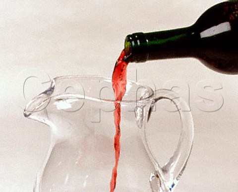 Decanting red wine into a jug