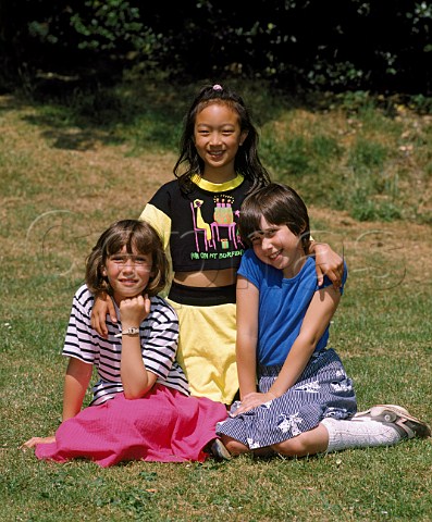 Three young girls sitting on the grass