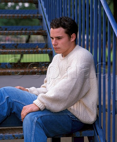 Teenage boy sitting on steps