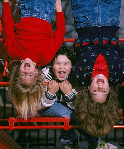 Two girls and a boy 13  14 years old on a climbing frame