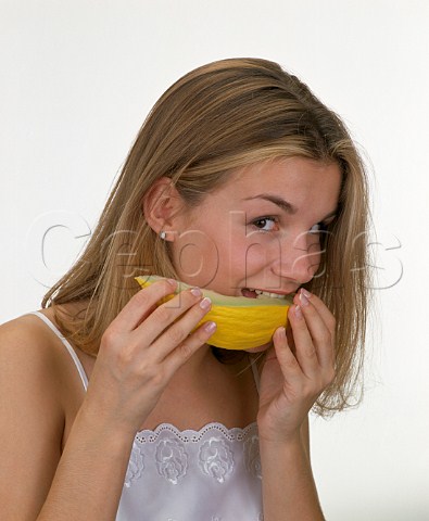 18year old girl eating slice of melon