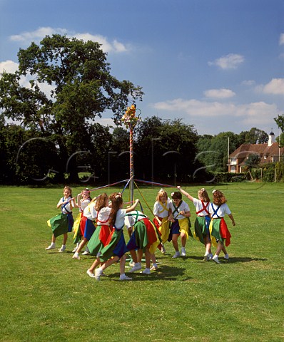 Young girls dancing round the maypole