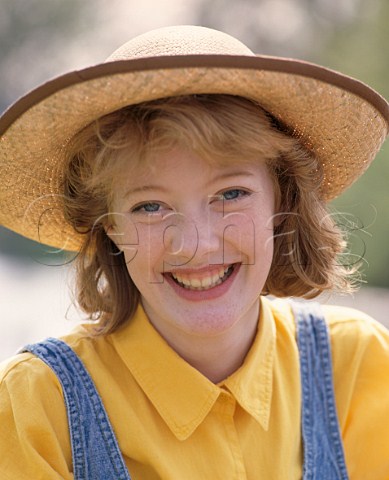 Young woman 16 wearing straw hat