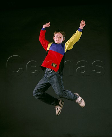 Teenage boy leaping into the air