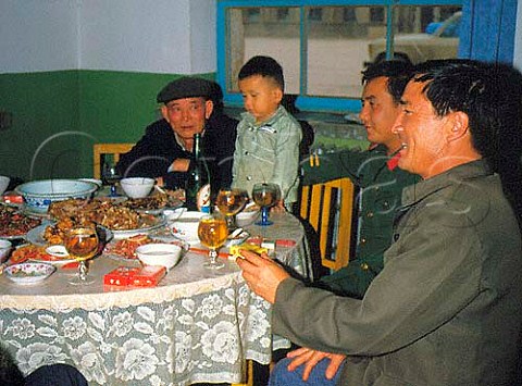 Men drinking beer with their meal at restaurant in   Turfan Xinjiang province China