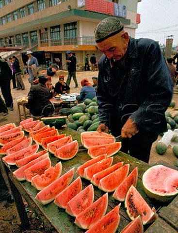 Selling watermelons in Turfan market                 Xinjiang Province China