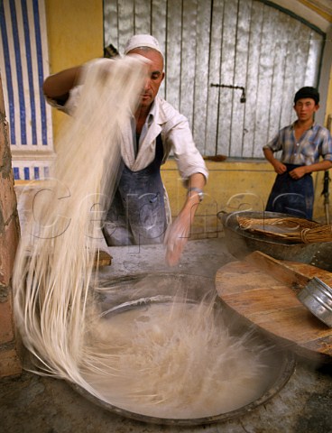 Boiling noodles in the Kashgar Sunday market   Xinjiang Province China