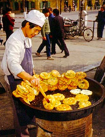 Street stall selling fried spinach and dough  rmqi Xinjiang Province China