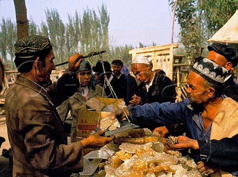 Selling lump sugar Kashgar Sunday Market   Xinjiang Province China