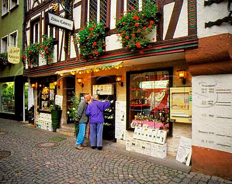 Haus Coblenz wine shop in the center of   Bernkastel with past flood heights of the Mosel   River marked on the wall to right  Germany            Mosel