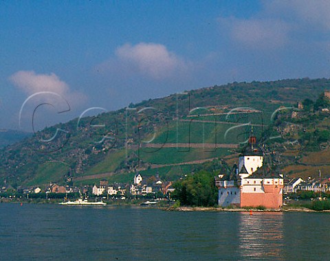 The 14thcentury Pfalz Castle built on an island in   the Rhine by the lords of Gutenfels Castle to   collect tolls from river traffic The Bluchertal   vineyard is beyond above the village of Kaub   Germany   Mittelrhein