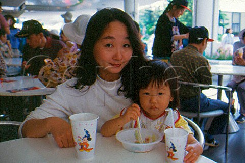 Japanese mother with young daughter in fast food restaurant Tokyo Japan