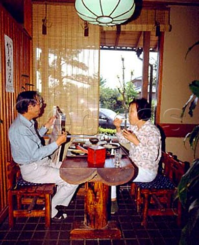 Couple eating soba Japanese noodles in a soba    udon restaurant Tokyo Japan