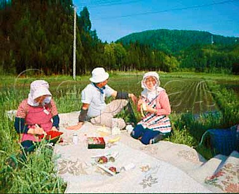 Farm workers take a short break during rice   planting Akita Prefecture Tohoku Northern Japan