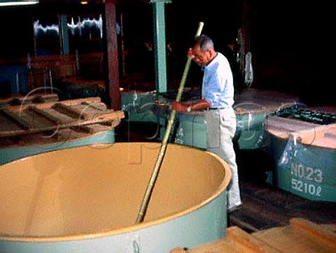 Stirring the second fermentation of sake at   Takahashi Sake Brewery Nagaoka Japan