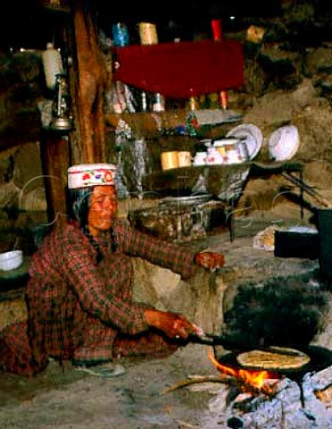 Baker Making chapaties in a small drystone hut in   the Batura valley North Pakistan