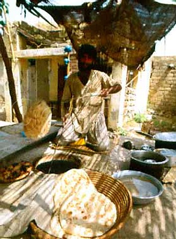 Baker Making oven baked chapaties in a village near   Rawalpindi Pakistan