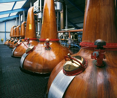 Still room of Laphroaig Distillery the three larger wash stills in foreground with the smaller spirit stills for the second distillation beyond Isle of Islay Argyllshire Scotland