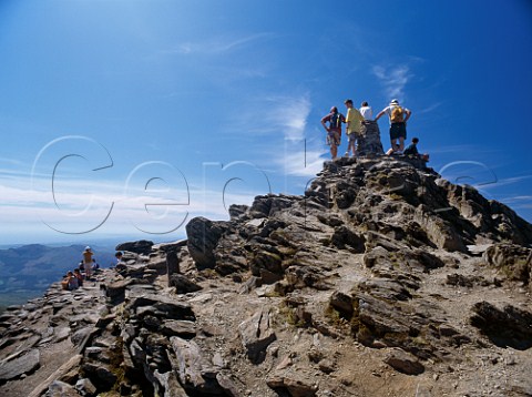 Walkers on the summit cairn of Mount Snowdon  Snowdonia National Park Wales
