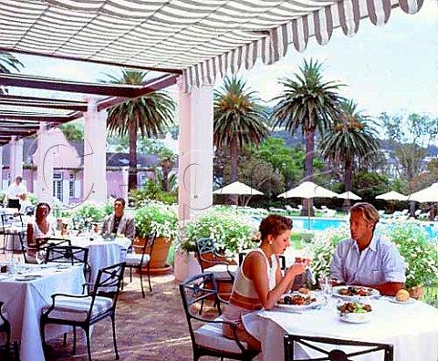 Mount Nelson Hotel couple dining at table by pool  Cape Town South Africa