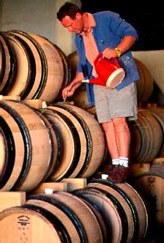 Winemaker Kevin Grant topping up   barrels in the cellars of   HamiltonRussell Vineyards   Hermanus South Africa  Overberg WO