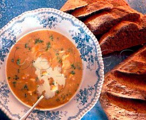 Smoked haddock soup with cream and a loaf of wholewheat crusty bread