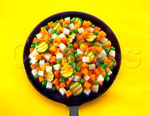 Mixed diced vegetables in a frying pan