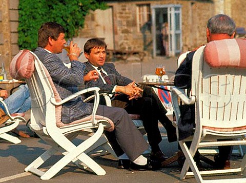 French businessmen talk over a leisurely beer on the   waterfront at Dinard Brittany