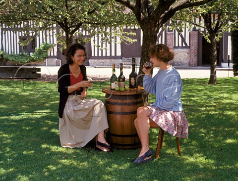 Women tasting vintage Calvados in the garden of the Pre Magloire distillery   Pontlvque BasseNormandie France 