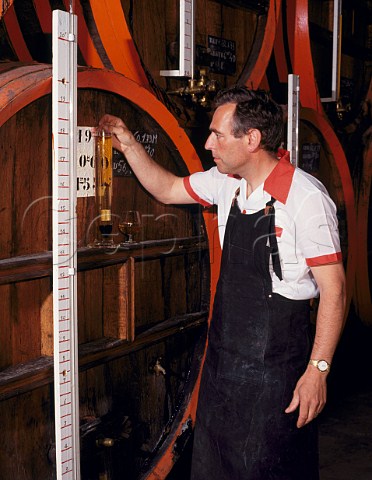 Checking alcohol level of 20year old vintage Calvados from the final blending barrel   Pre Magloire Pontlvque Normandy France