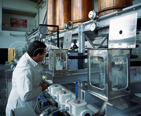 Checking the quality of Gin distillate as it flows from the still   United Distillers Gordons Tanqueray etc Laindon Essex England