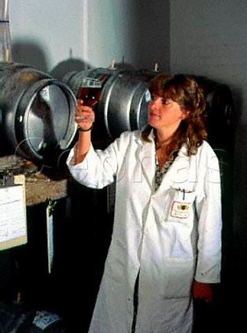 Moira Williams the packaging brewer checking   sample from a cask of Gales HSB at the brewery of   George Gale  Co Horndean Hampshire England