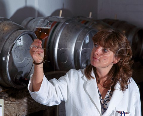 Brewer checking sample from a cask of Gales HSB at the brewery of George Gale  Co Horndean Hampshire England