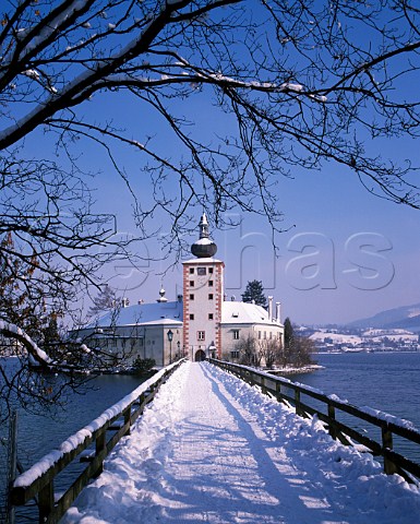 Snow covered bridge to Orth Castle on Traunsee Salzkammergut Austria