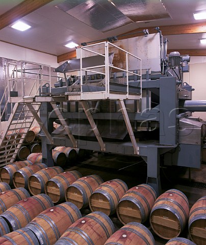 Sparkling wine press surrounded by new oak barrels  of red wine in the winery of Montana at Blenheim Marlborough New Zealand