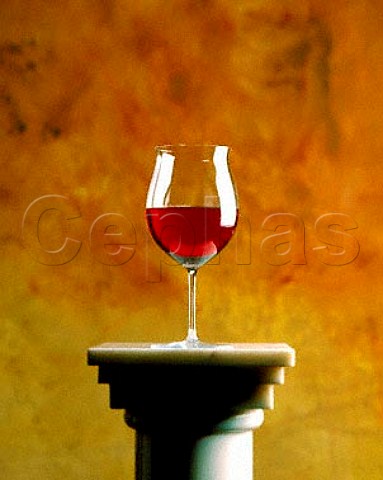 Glass of red wine on a column